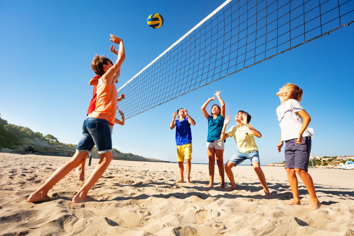 Kids playing beach volleyball in Fort Morgan, Alabama